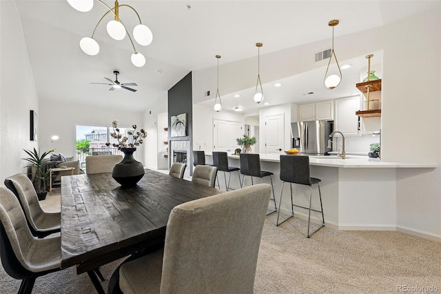 dining space featuring light colored carpet, baseboards, ceiling fan, high vaulted ceiling, and recessed lighting