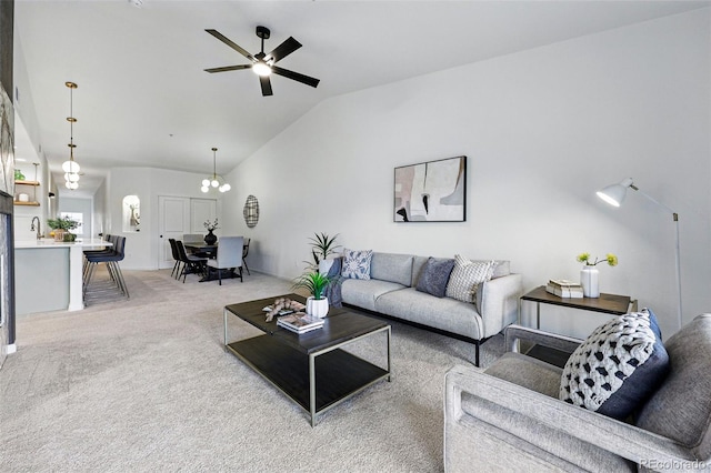 living area featuring vaulted ceiling, light colored carpet, and ceiling fan