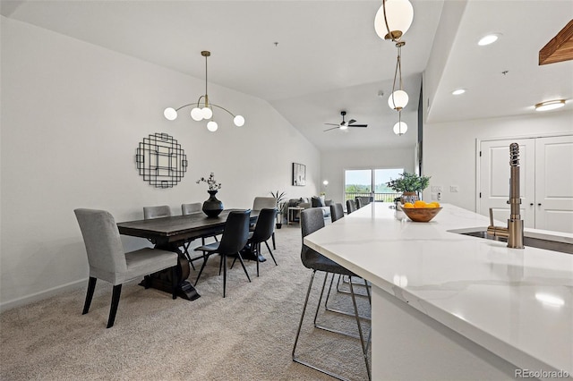 dining room with light carpet, a ceiling fan, vaulted ceiling, recessed lighting, and baseboards