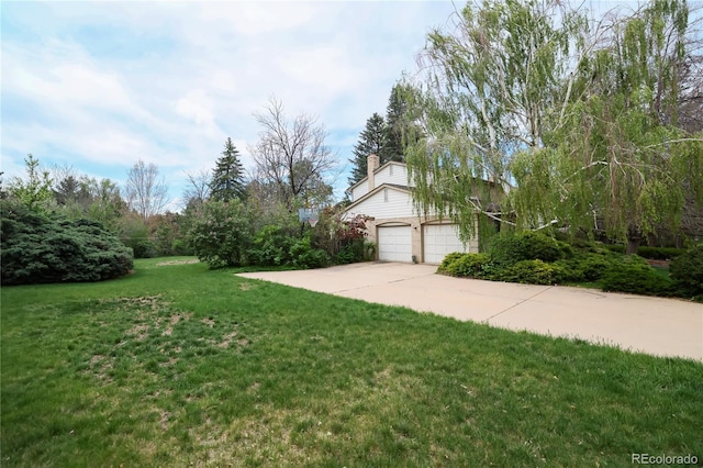 4070 S Hudson Way, Englewood, CO 80113 - view of green lawn with concrete driveway and a garage