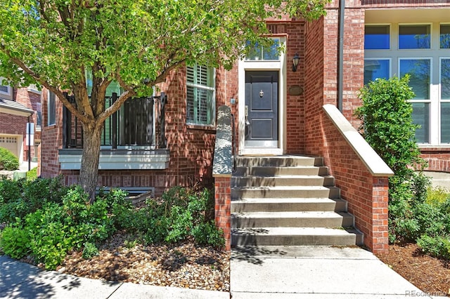 property entrance with brick siding
