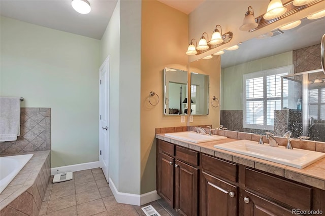 full bathroom with a stall shower, a garden tub, double vanity, tile patterned flooring, and baseboards