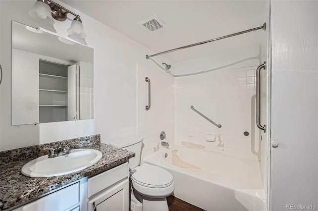 full bathroom with tiled shower / bath combo, toilet, and vanity