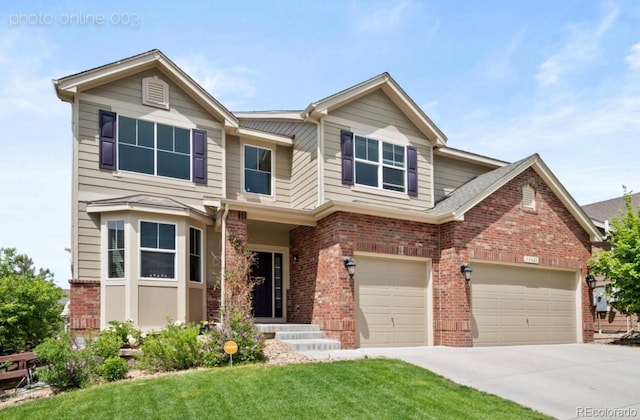 view of front of home featuring a garage and a front yard