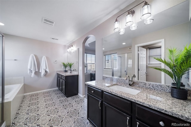 bathroom with independent shower and bath and vanity