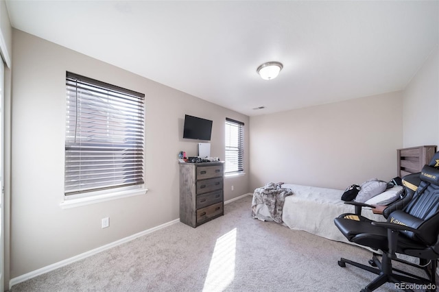 bedroom featuring light carpet