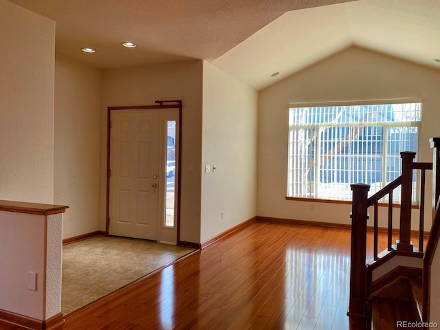 1022 Morning Dove Dr, Longmont, CO 80504 - entryway with hardwood / wood-style floors, vaulted ceiling, and baseboards