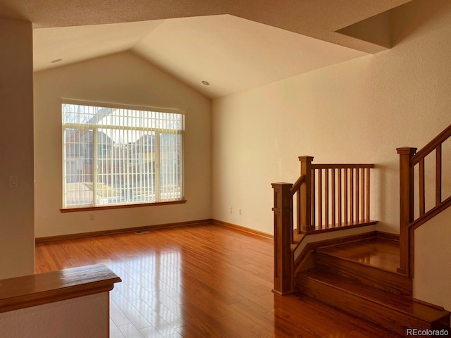 1022 Morning Dove Dr, Longmont, CO 80504 - stairs with wood finished floors, lofted ceiling, and baseboards