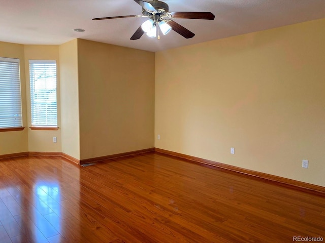 1022 Morning Dove Dr, Longmont, CO 80504 - spare room with wood finished floors, ceiling fan, and baseboards