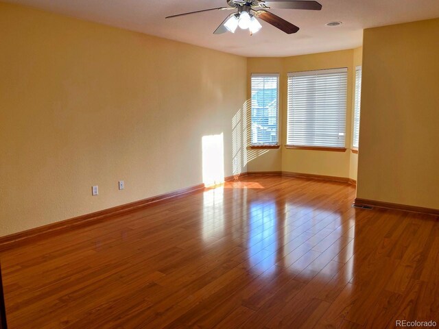 1022 Morning Dove Dr, Longmont, CO 80504 - unfurnished room with a ceiling fan, wood finished floors, and baseboards