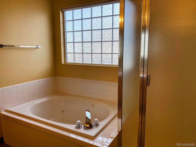 1022 Morning Dove Dr, Longmont, CO 80504 - bathroom with a textured wall, a jetted tub, and a shower stall