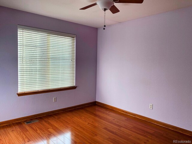 1022 Morning Dove Dr, Longmont, CO 80504 - spare room with a ceiling fan, wood finished floors, and baseboards