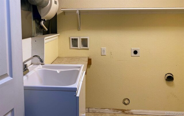 1022 Morning Dove Dr, Longmont, CO 80504 - laundry area with hookup for an electric dryer, water heater, and a sink