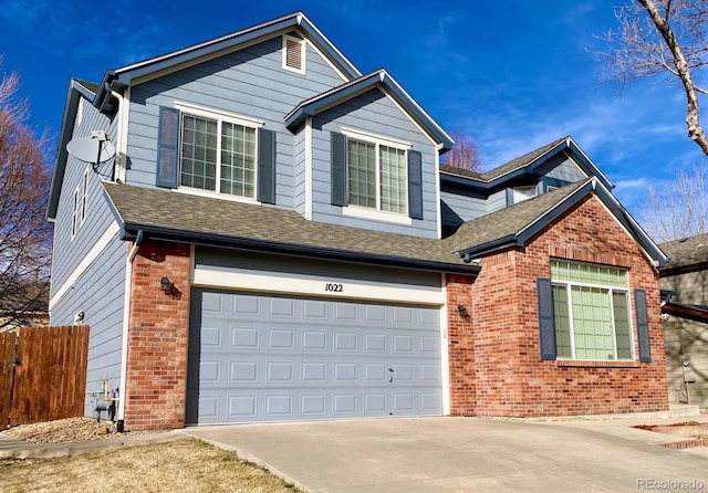 1022 Morning Dove Dr, Longmont, CO 80504 - view of front of property featuring brick siding, a garage, driveway, and a shingled roof