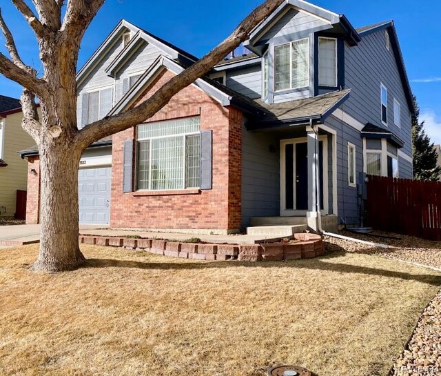 1022 Morning Dove Dr, Longmont, CO 80504 - view of front of home with brick siding and a garage