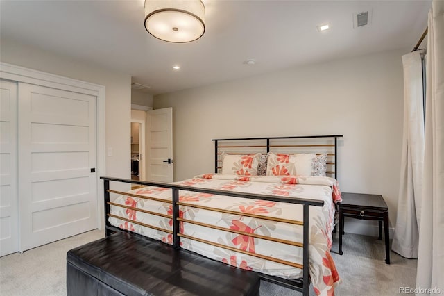 bedroom featuring washer / clothes dryer and light carpet