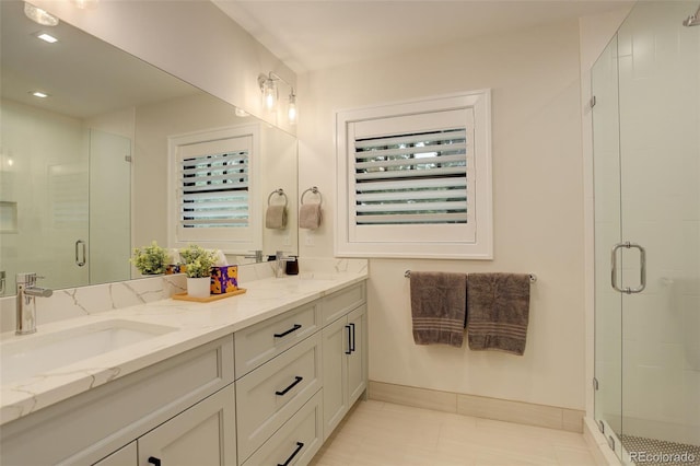 bathroom featuring vanity and an enclosed shower