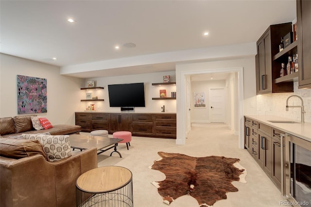 living room featuring sink, light colored carpet, and beverage cooler