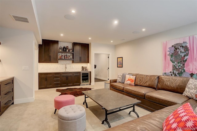 carpeted living room featuring beverage cooler and indoor wet bar