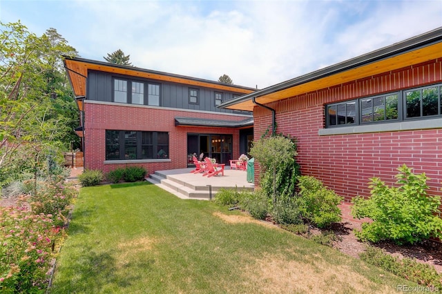 back of house featuring a patio area and a lawn