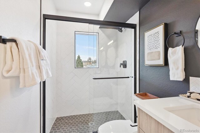 5128 W 26th Ave Unit 101, Denver, CO 80212 - bathroom featuring toilet, a textured wall, a stall shower, and vanity