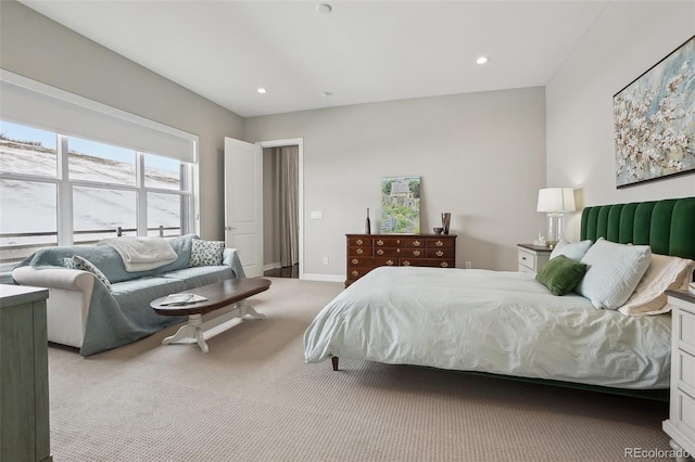 bedroom with light carpet, recessed lighting, and baseboards