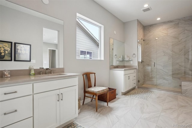 bathroom featuring recessed lighting, two vanities, visible vents, a stall shower, and a sink