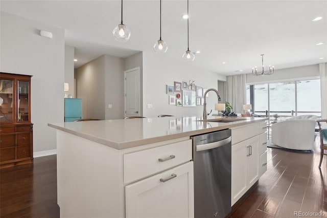 kitchen featuring dark wood-type flooring, a center island with sink, dishwasher, and a sink