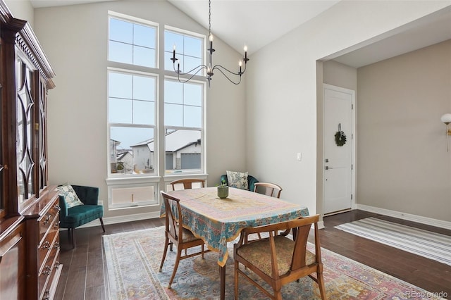 dining room with high vaulted ceiling, baseboards, dark wood finished floors, and a notable chandelier