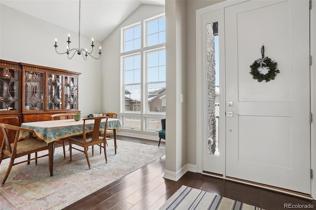 dining area featuring high vaulted ceiling, a notable chandelier, baseboards, and dark wood-style flooring