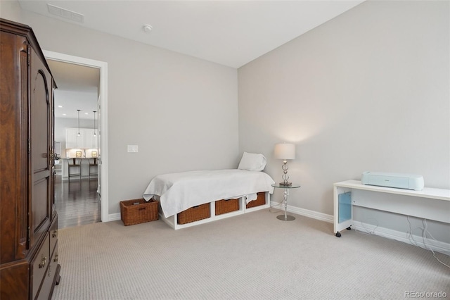 bedroom featuring light carpet, baseboards, and visible vents