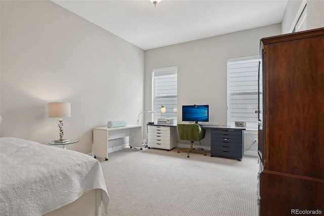 bedroom featuring light carpet and baseboards