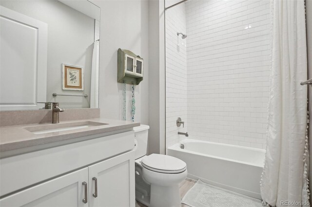 full bathroom with vanity, toilet, and shower / tub combo with curtain