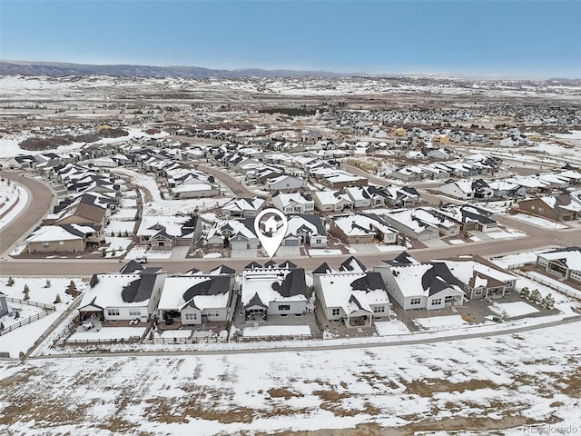 snowy aerial view with a residential view