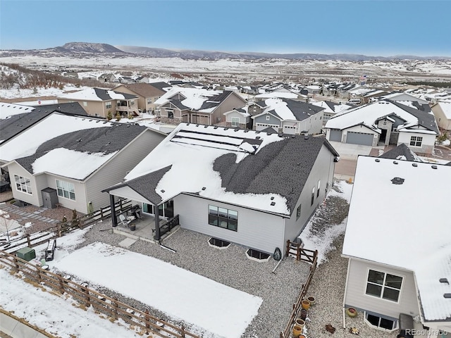 snowy aerial view featuring a residential view