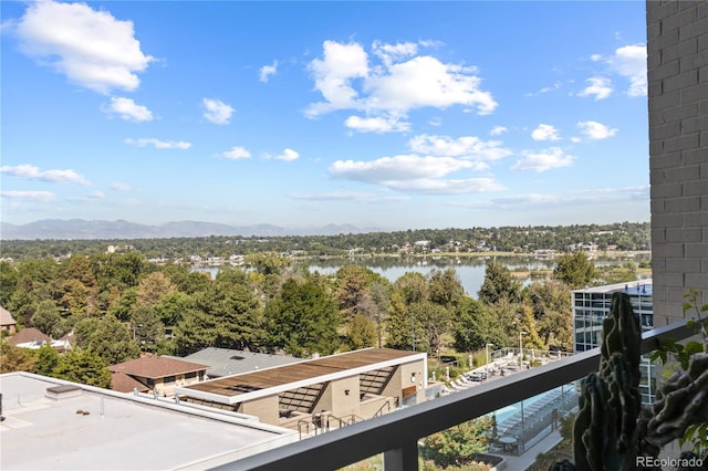 balcony featuring a water and mountain view