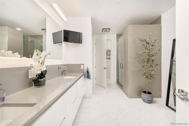 bathroom with walk in shower and vanity