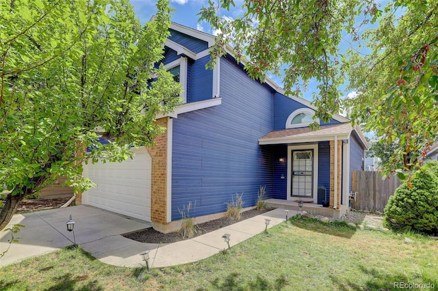 view of front of property featuring a garage and a front lawn