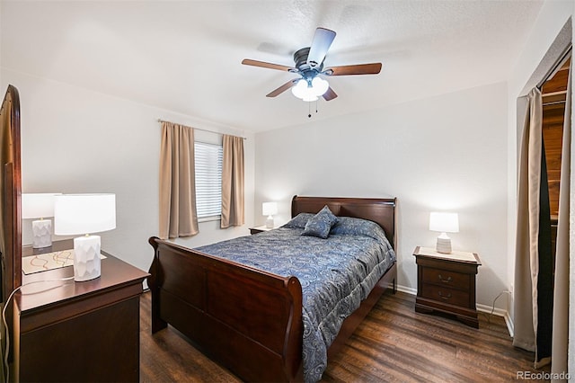 bedroom featuring ceiling fan, baseboards, and dark wood finished floors