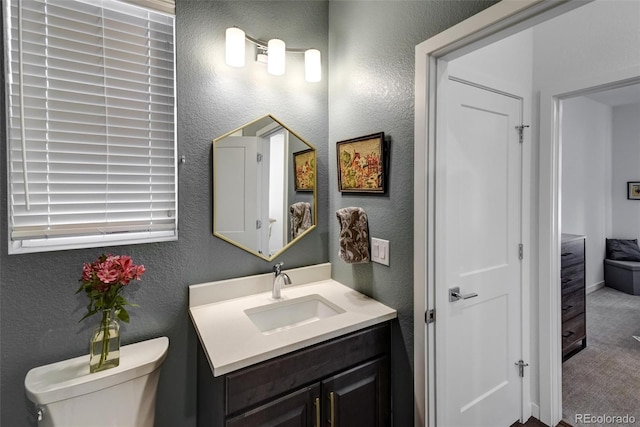 bathroom featuring toilet and vanity