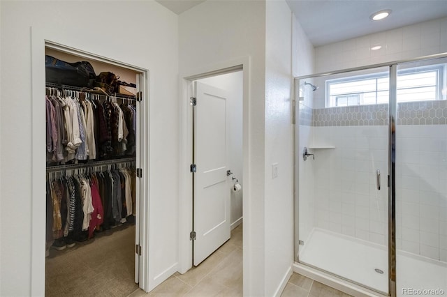 bathroom with tile patterned flooring and a shower with shower door