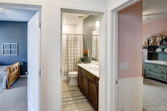 full bathroom featuring toilet, shower / bath combination with curtain, and vanity