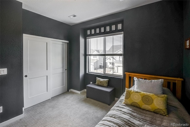 carpeted bedroom with a closet