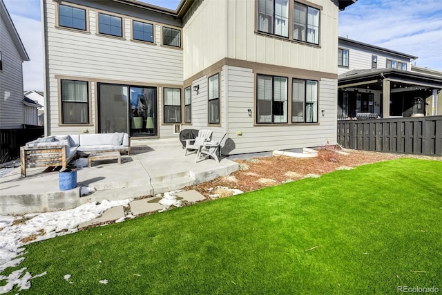 rear view of property with a lawn, a patio, and outdoor lounge area