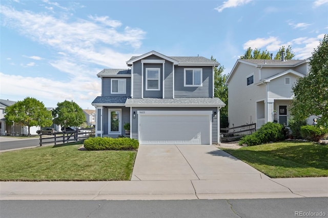 view of property featuring a garage and a front yard