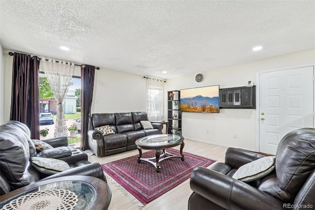 11941 Bellaire St Unit B, Thornton, CO 80233 - living area with a textured ceiling, wood finished floors, and recessed lighting