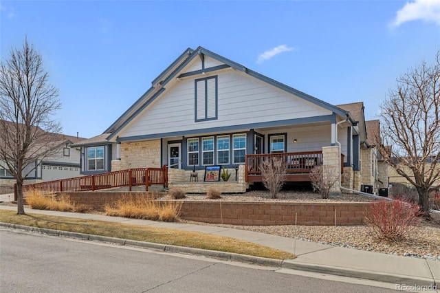 view of front of house with a porch and stone siding