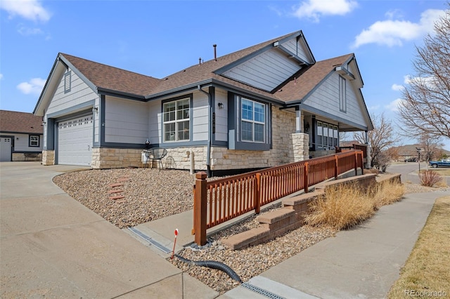 craftsman inspired home featuring stone siding, driveway, a shingled roof, and a garage