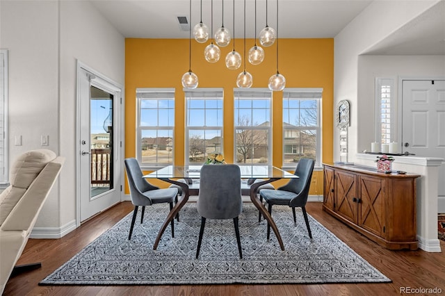 dining space featuring visible vents, baseboards, and dark wood-style flooring