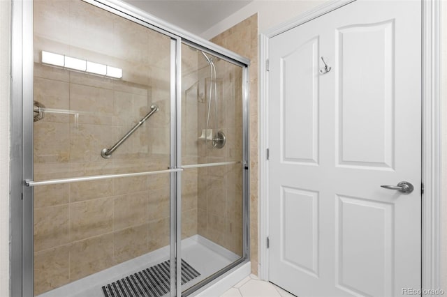 bathroom featuring tile patterned flooring and a shower stall